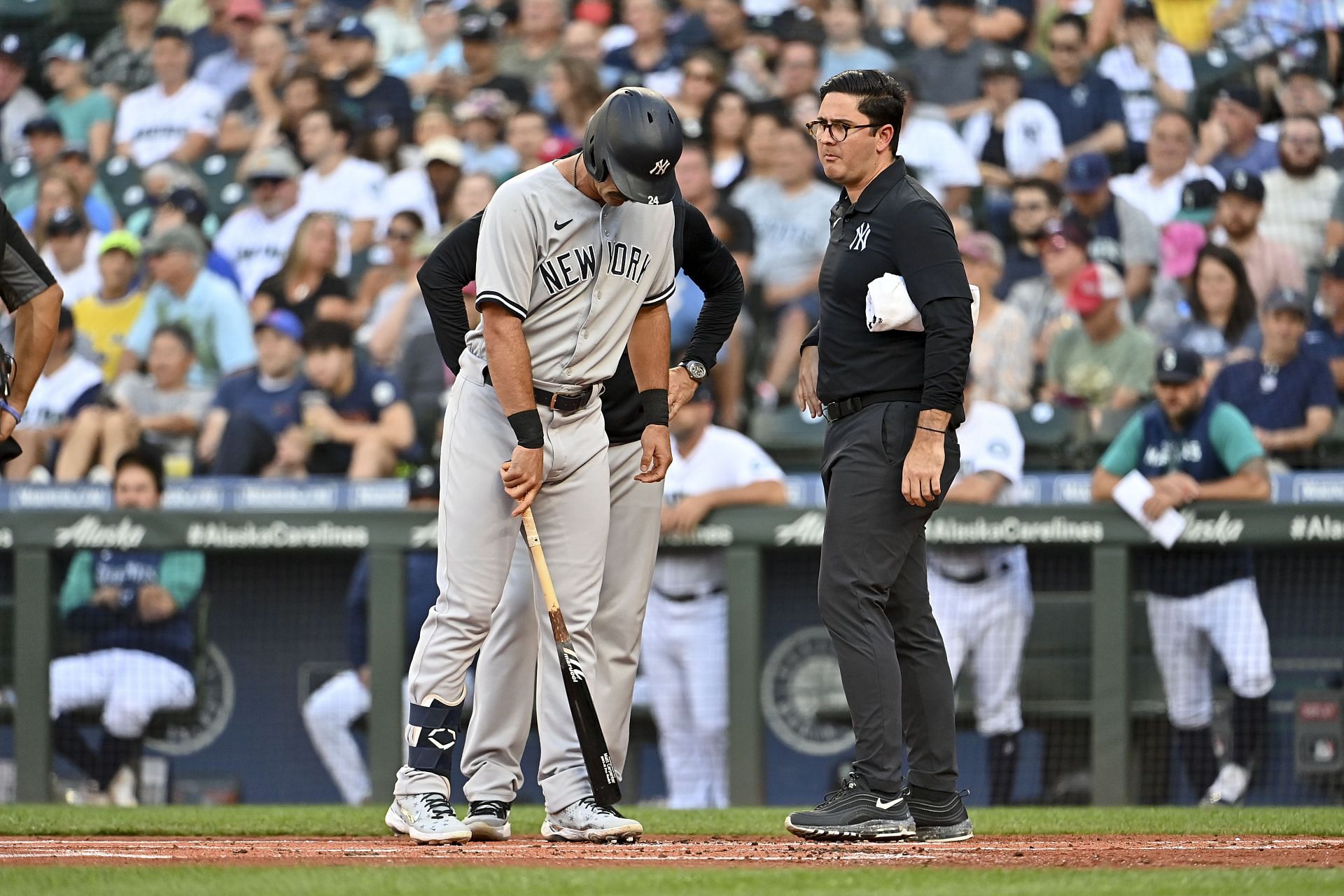 Matt Carpenter #24 of the New York Yankees points with his bat to where the foul tip ball hit him during the first inning against the Seattle Mariners at T-Mobile Park on August 08, 2022