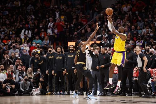 LeBron James shoots over a defender.