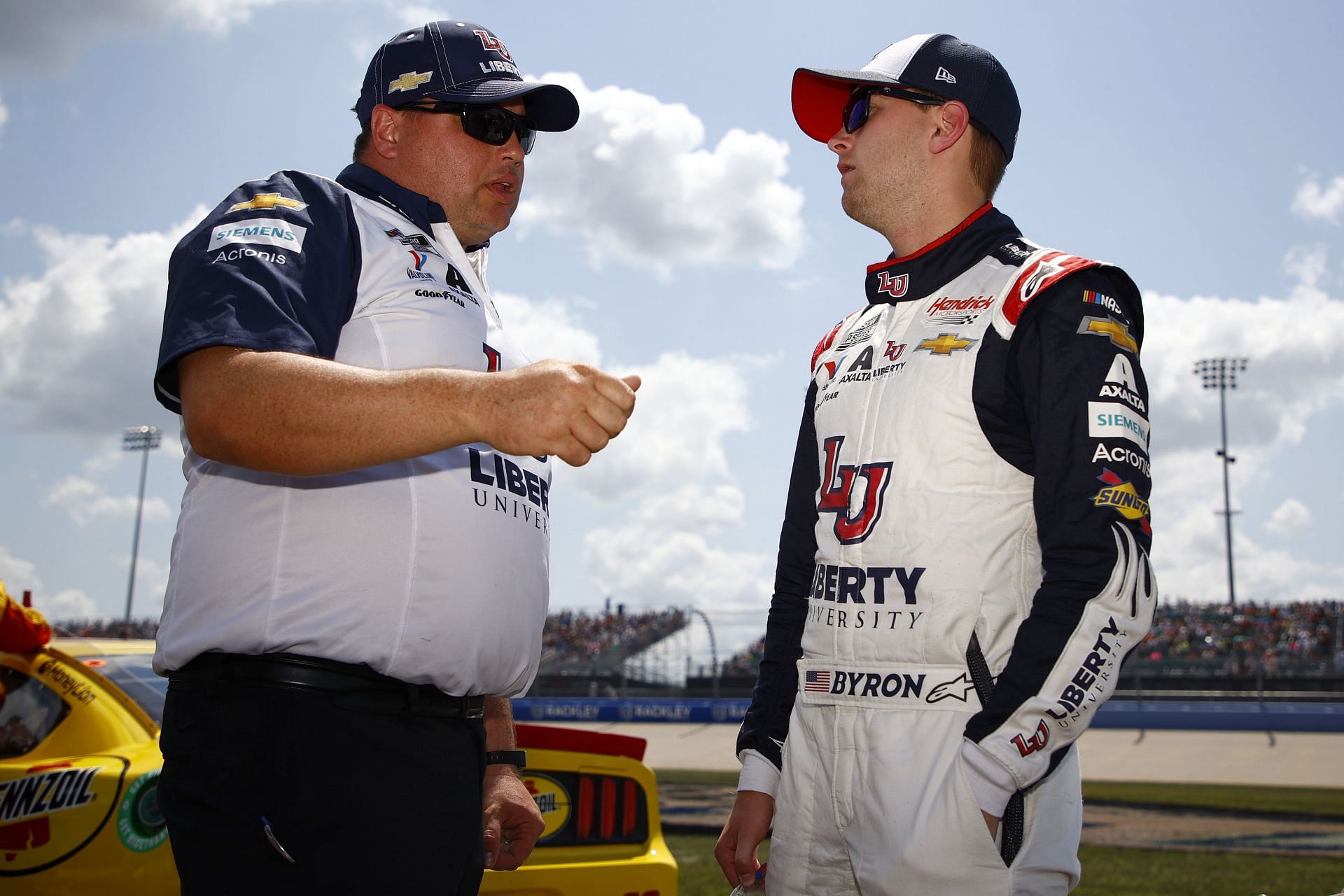 William Byron (right) and crew chief Rudy Fugle talk on the grid before the NASCAR Cup Series Ally 400 at Nashville Superspeedway