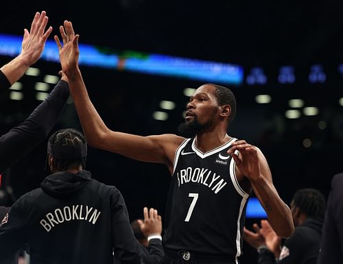 Kevin Durant celebrates heading into the timout