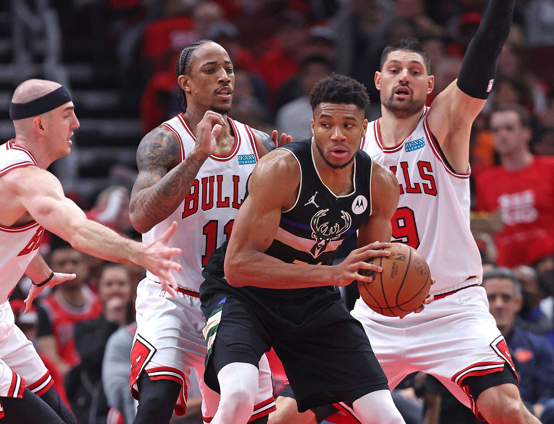 Giannis Antetokounmpo guarded by Chicago Bulls players in the NBA playoffs.