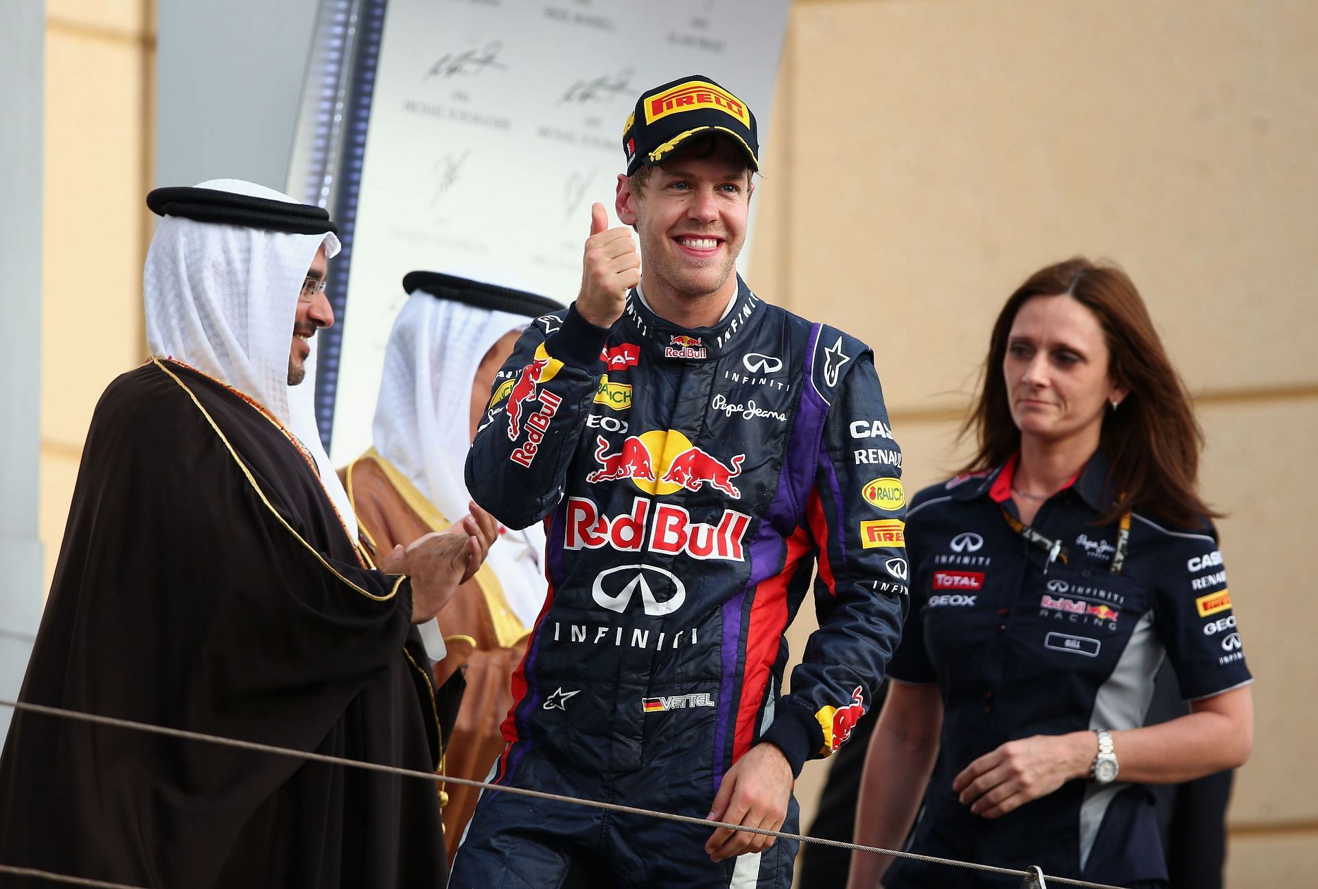 Sebastian Vettel celebrates on the podium alongside Gill Jones after winning the Bahrain Formula One Grand Prix at the Bahrain International Circuit on April 21, 2013, in Sakhir, Bahrain (Photo by Clive Mason/Getty Images)