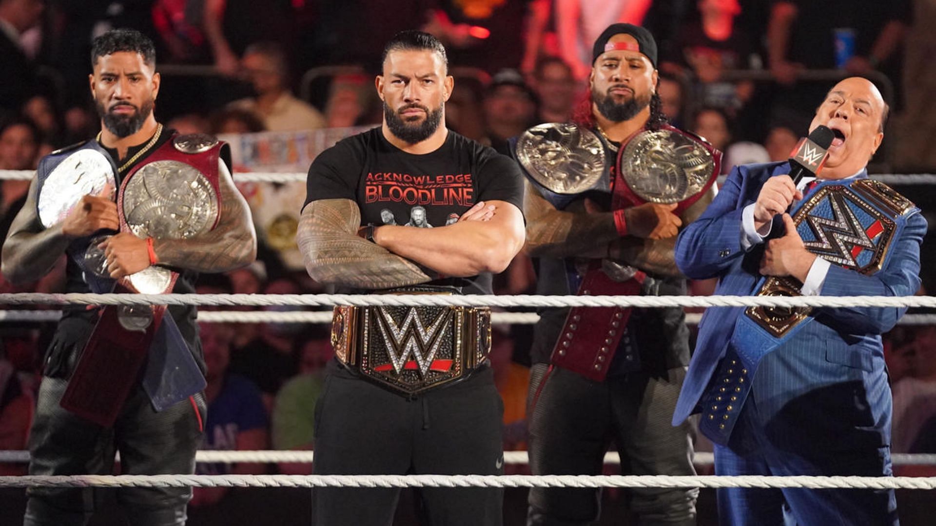 The Bloodline from left to right: Jey Uso, Roman Reigns, Jimmy Uso, and Paul Heyman