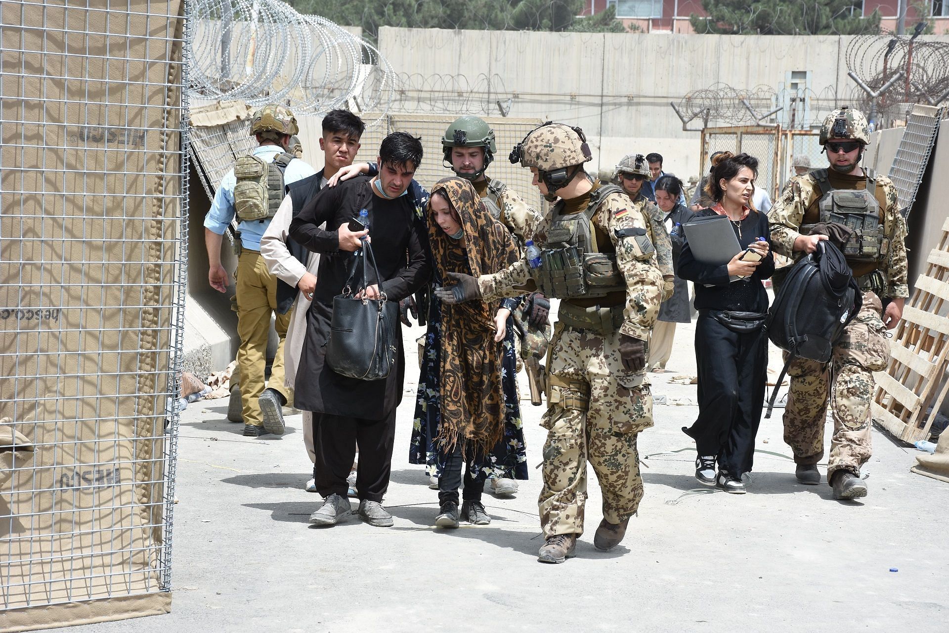 Soldiers helping Afghans during the evacuation of Kabul (Image via Getty)