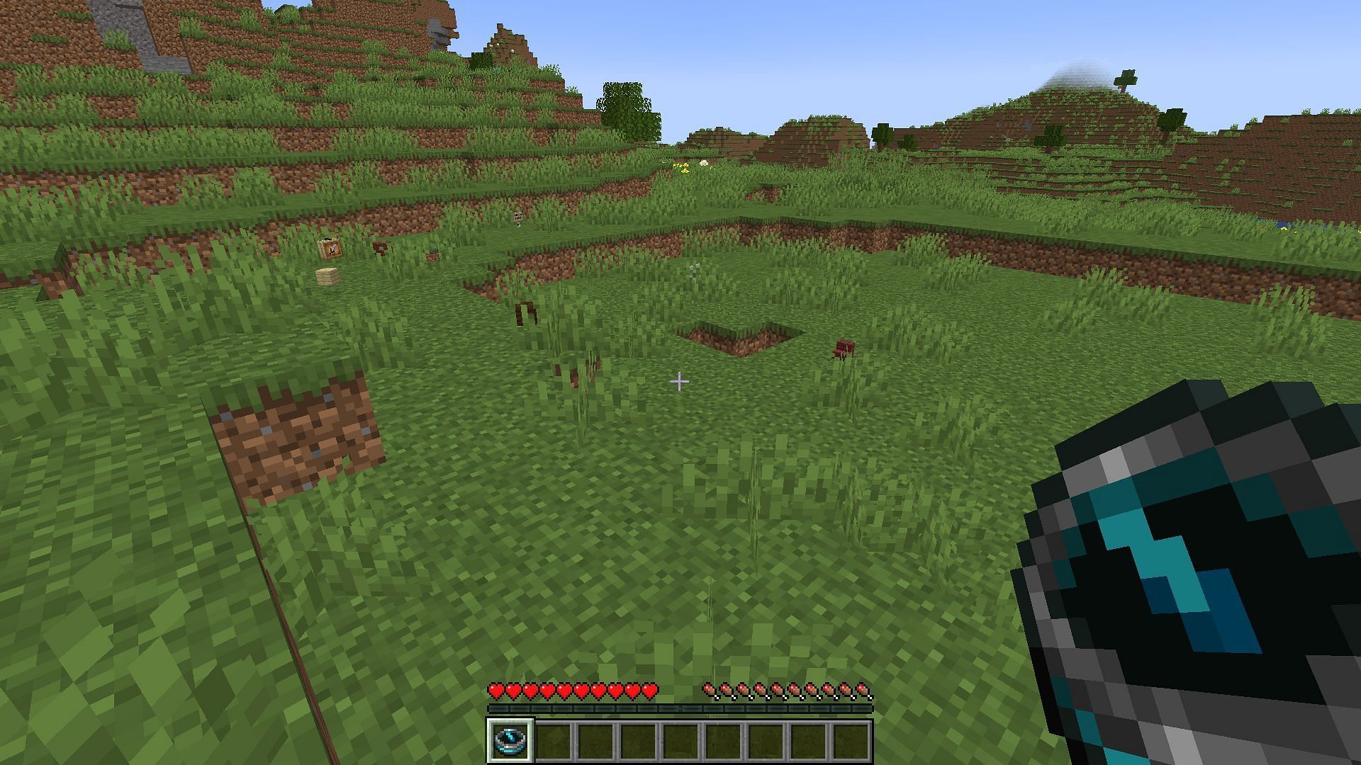 A recovery compass pointing towards a player&#039;s items on the ground (Image via Minecraft)