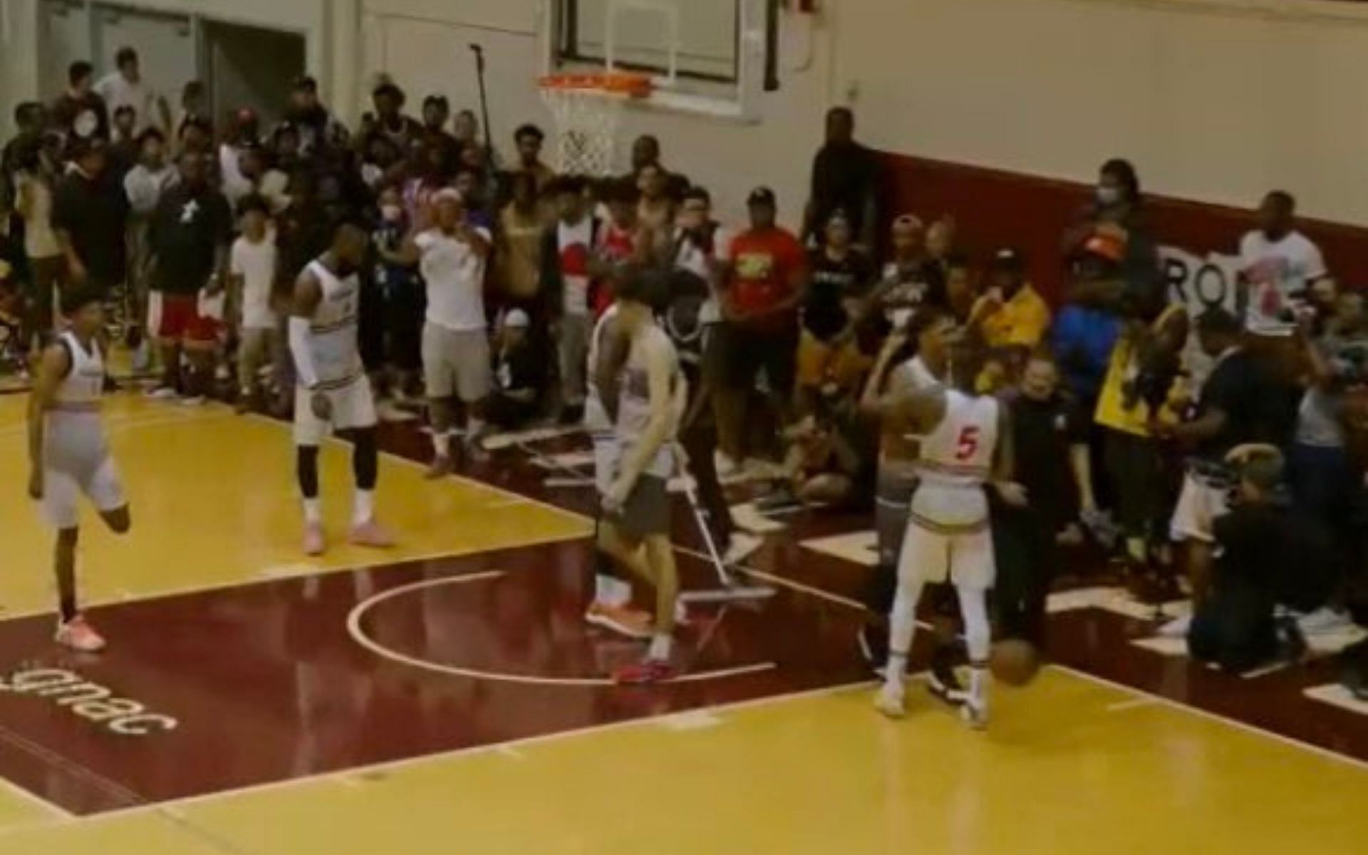 Paolo Banchero and Dejounte Murray dap each other during The CrawsOver Pro-Am game
