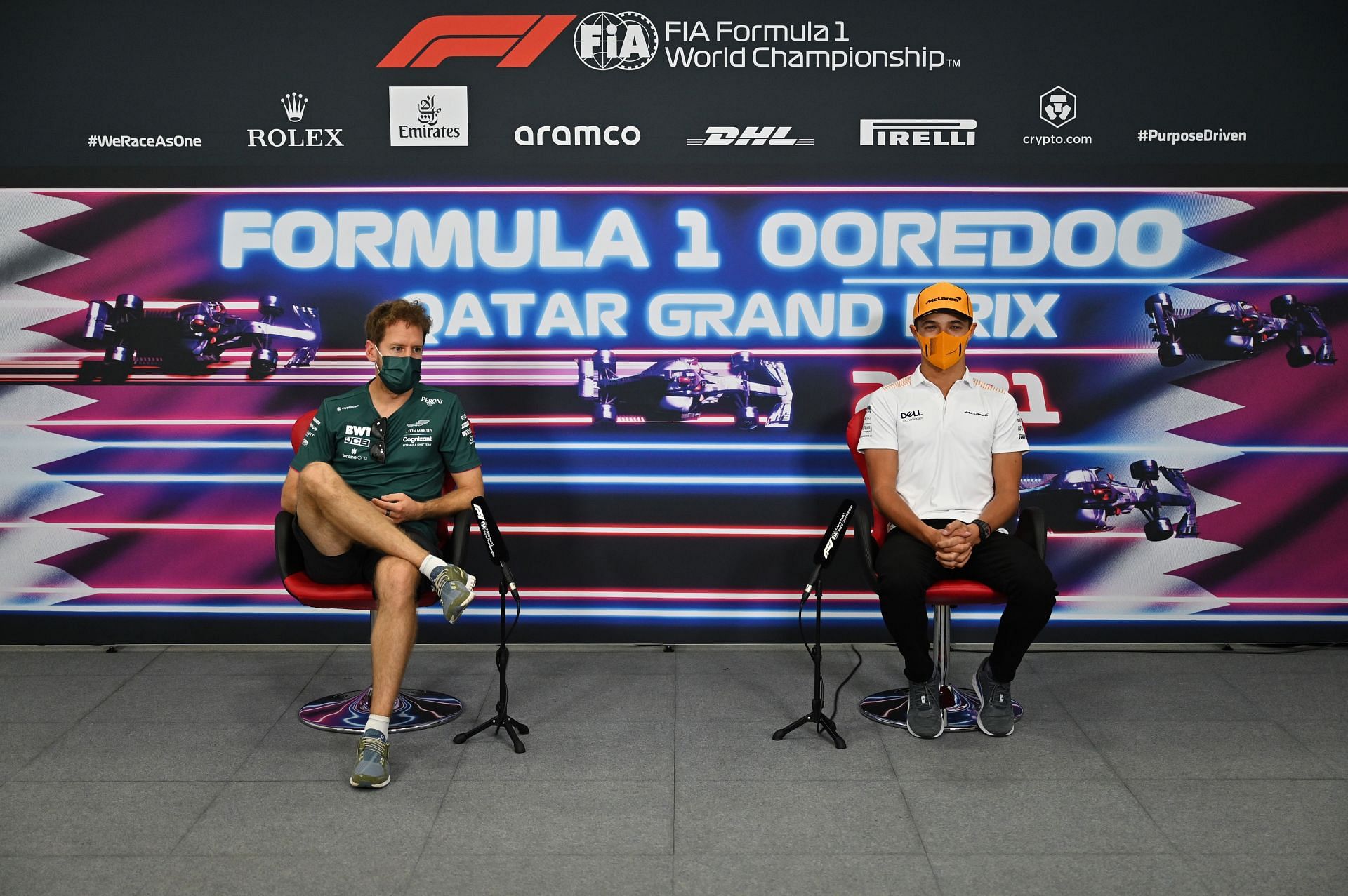 Sebastian Vettel and Lando Norris talk in the Drivers Press Conference during previews ahead of the F1 Grand Prix of Qatar. (Photo by Andrej Isakovic - Pool/Getty Images)