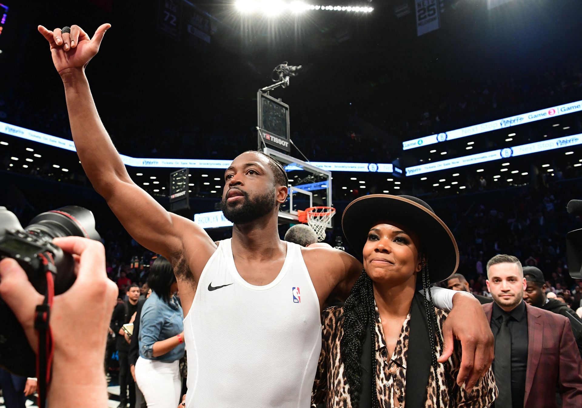 Dwyane Wade of the Miami Heat thanks the fans with his wife, Gabrielle Union, after his last game.