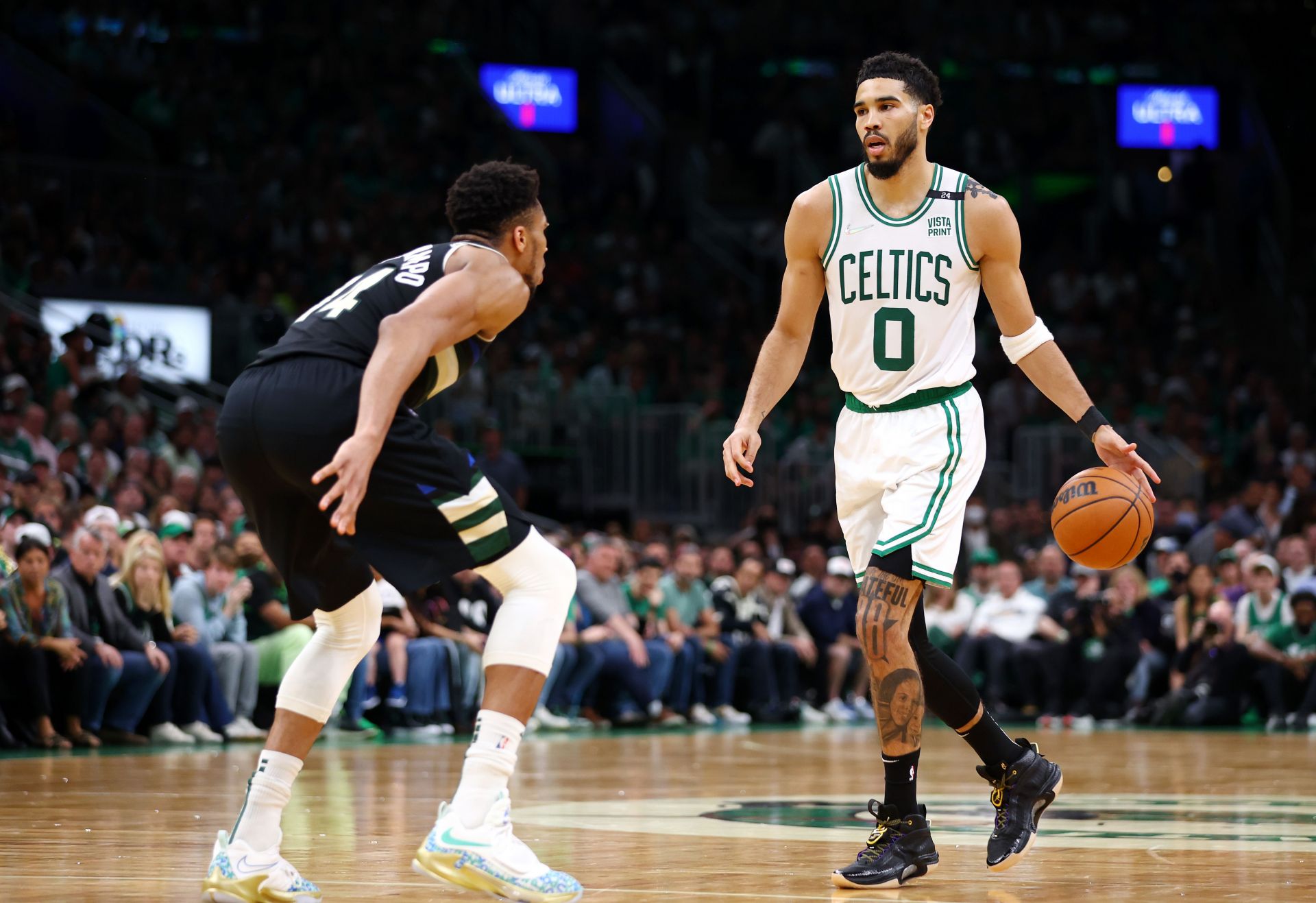 Jayson Tatum in action against Giannis Antetokounmpo