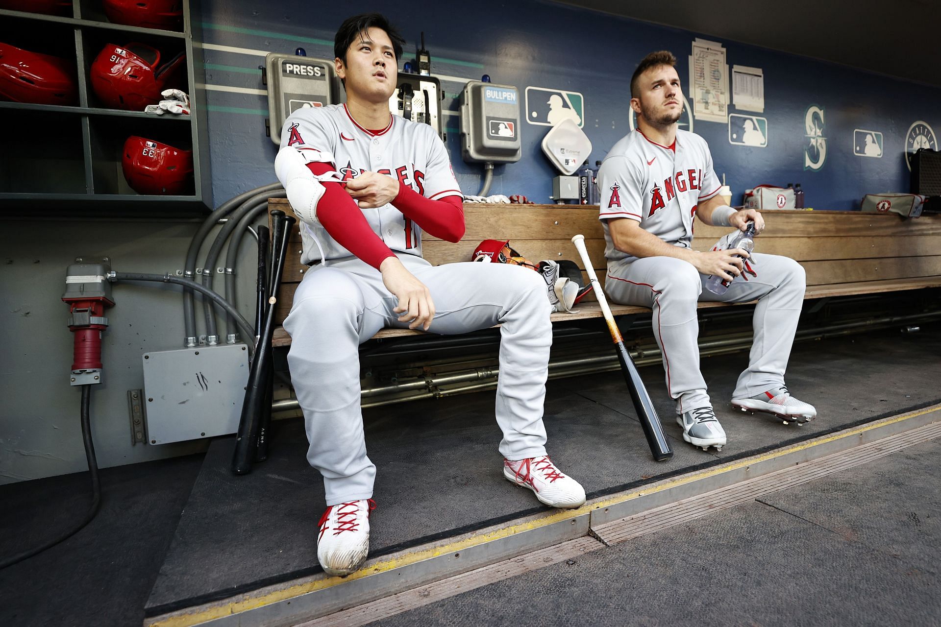 Ohtani and Mike Trout sitting in the dugout