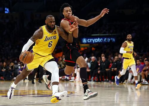 LeBron James and Scottie Barnes in action during a Toronto Raptors and Los Angeles Lakers regular-season game in 2021-22.