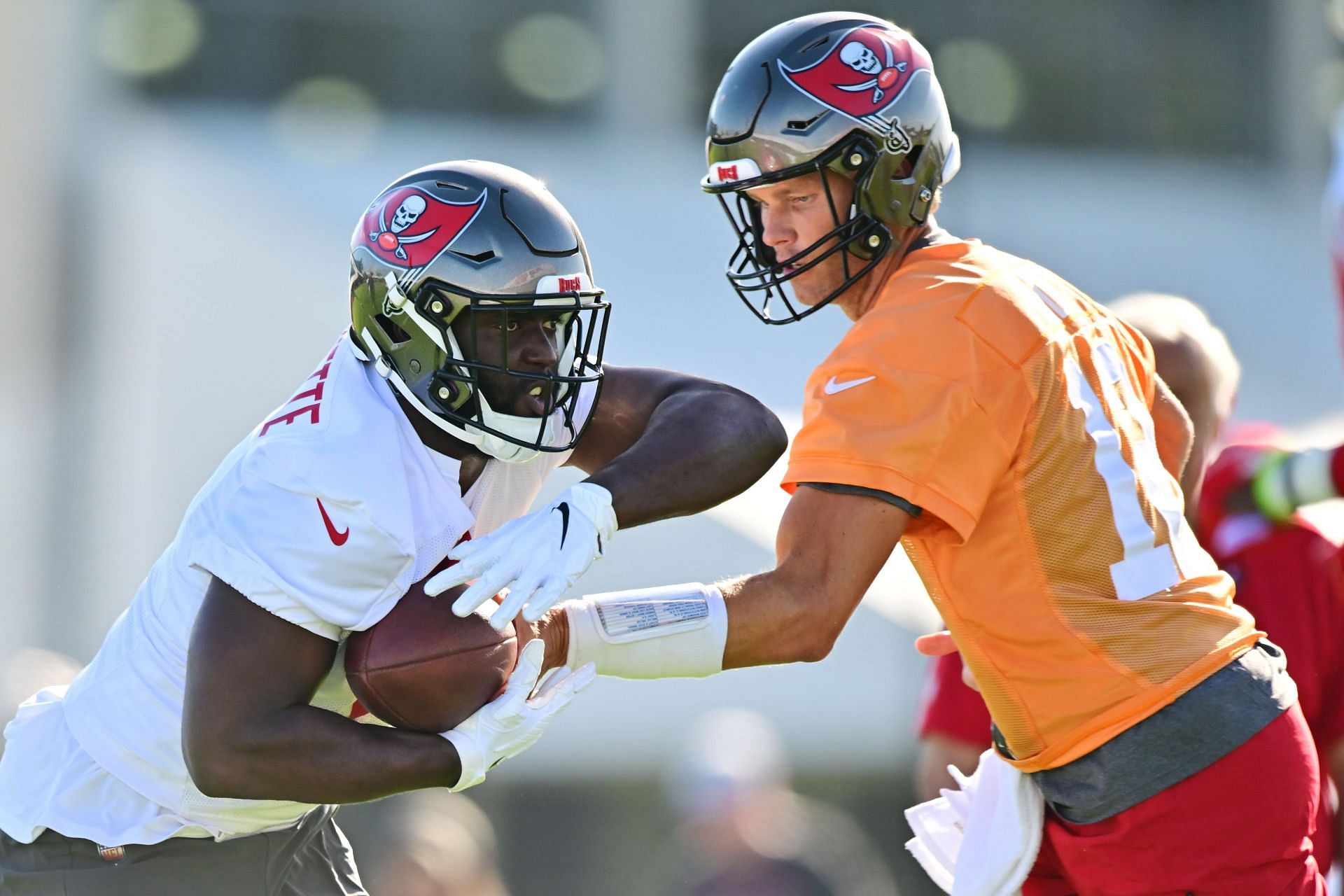 Tampa Bay Buccaneers quarterback Tom Brady hands the ball off in training camp