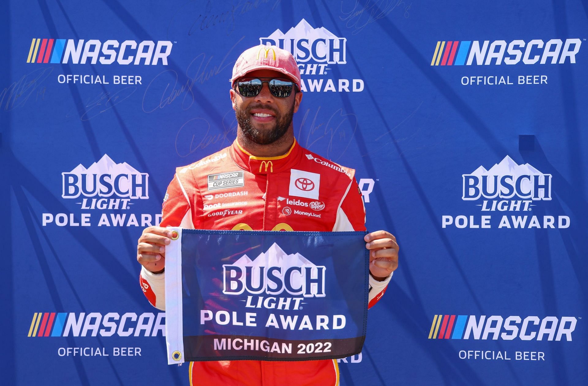 Bubba Wallace Jr. poses for photos after winning the pole award during qualifying for the NASCAR Cup Series FireKeepers Casino 400 at Michigan International Speedway (Photo by Mike Mulholland/Getty Images