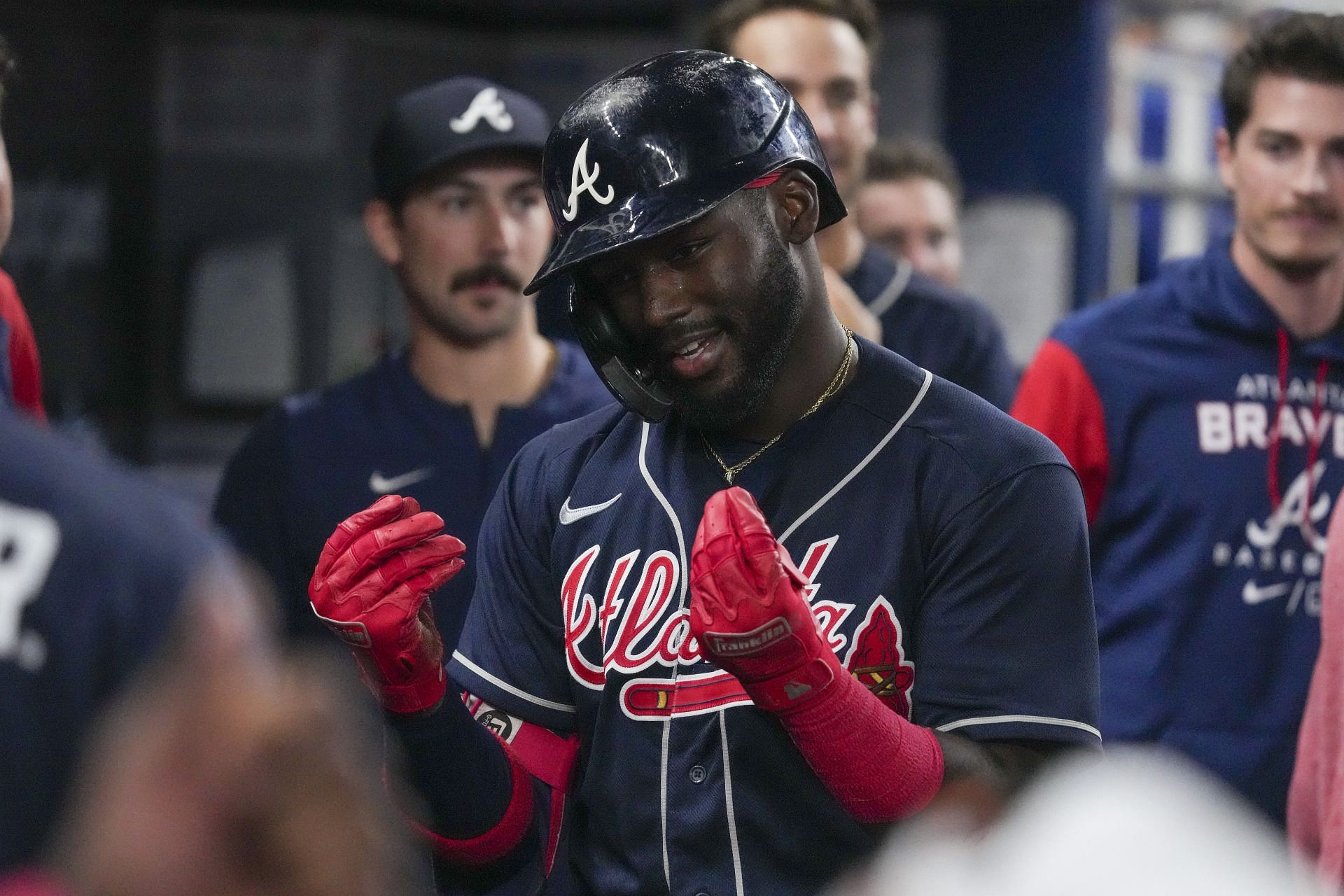 Michael Harris II of the Atlanta Braves celebrates in the dugout with teammates.