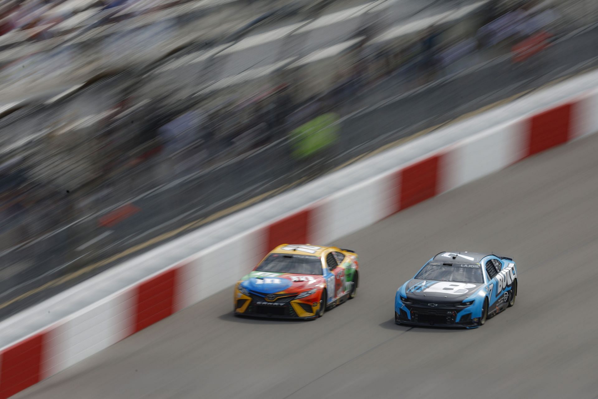 Corey LaJoie (right) and Kyle Busch (left) race during the NASCAR Cup Series Federated Auto Parts 400 at Richmond Raceway