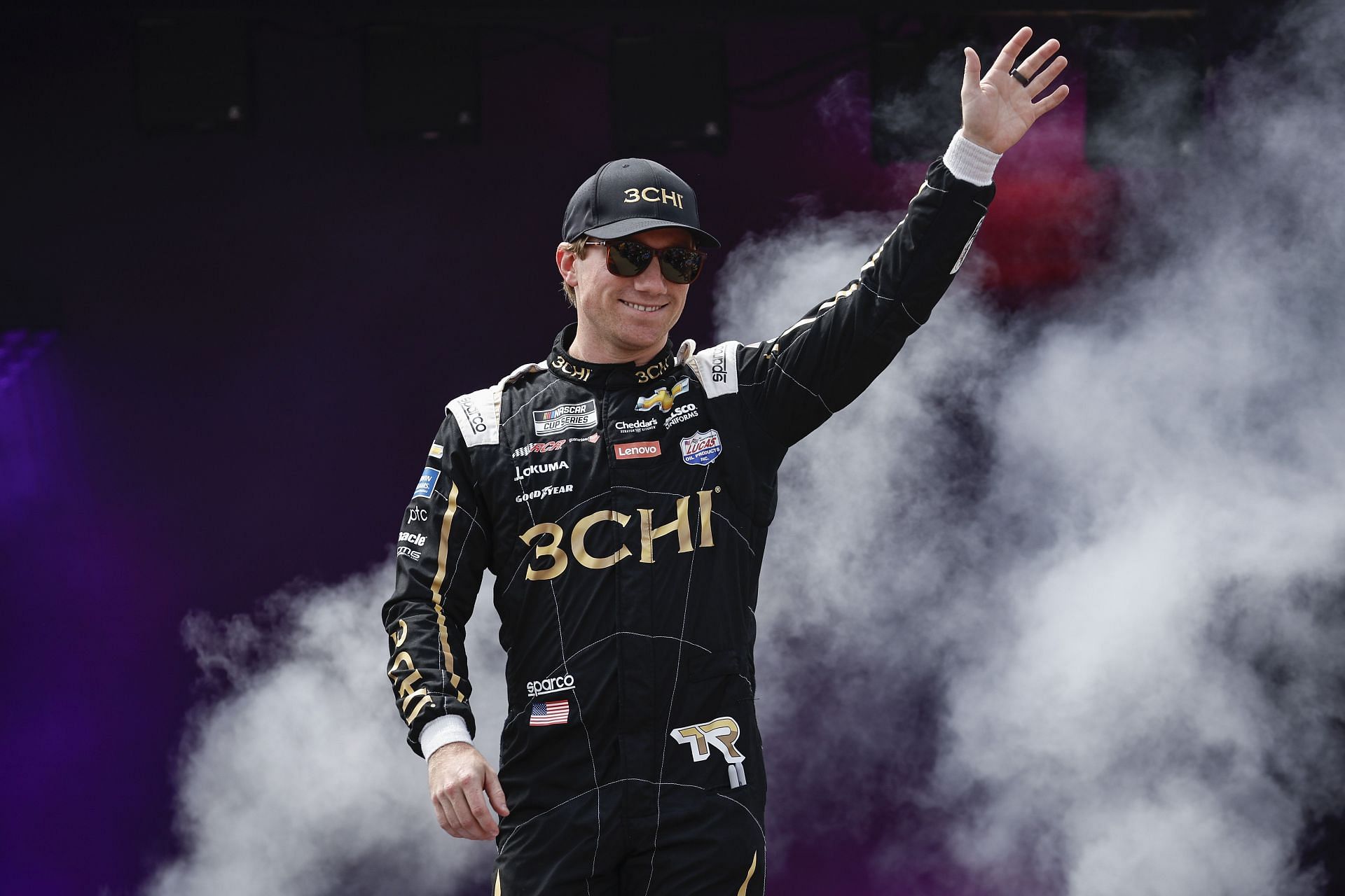 Tyler Reddick waves to fans as he walks onstage during driver intros before the 2022 NASCAR Cup Series Federated Auto Parts 400 at Richmond Raceway in Richmond, Virginia (Photo by Chris Graythen/Getty Images)