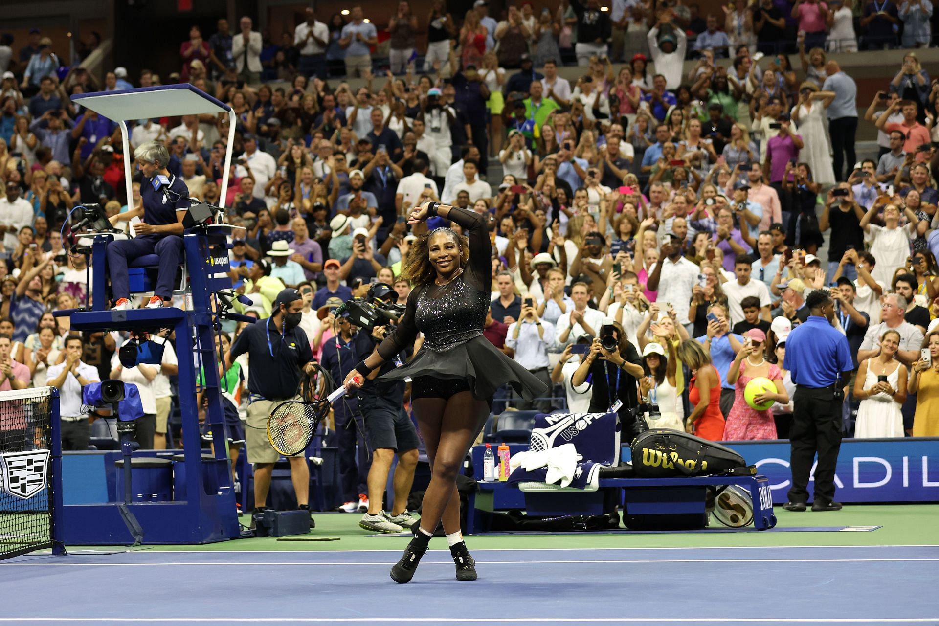 Serena Williams does her traditional post-match celebration, a twirl, after beating Danka Kovinic in the first round of the US Open.