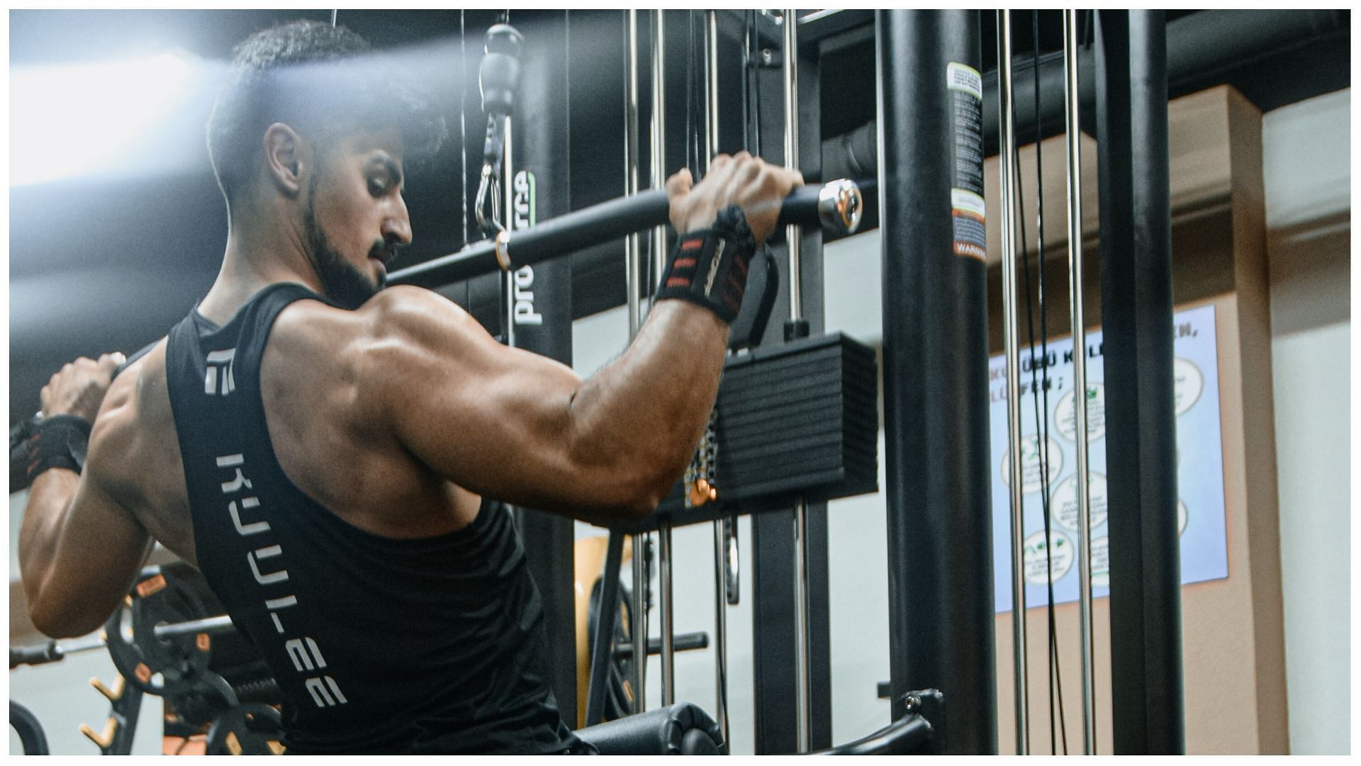 Lat pull-down is the workout to do if you want to develop enviable lats. (Image via Pexels/ Korhan Erdol)