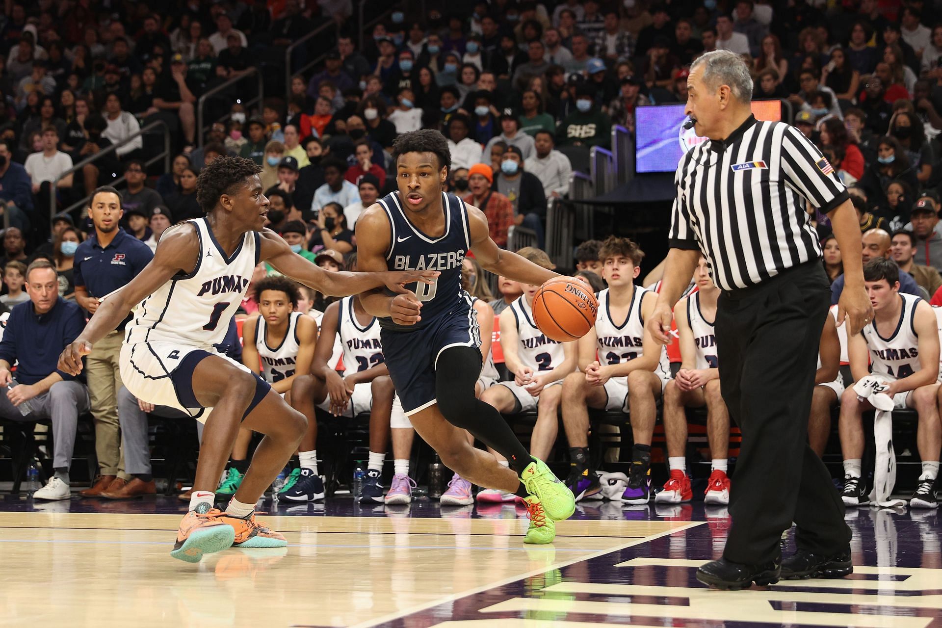 Bronny James drives past a defender