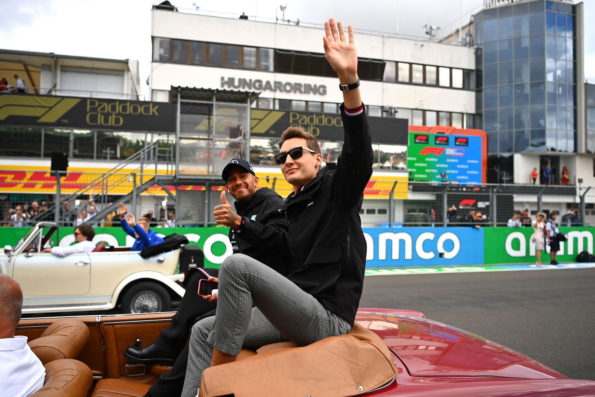 Mercedes&#039; Lewis Hamilton (background) and George Russell (foreground) wave at the fans during the drivers&#039; parade ahead of the 2022 F1 Hungarian GP (Photo by Dan Mullan/Getty Images)