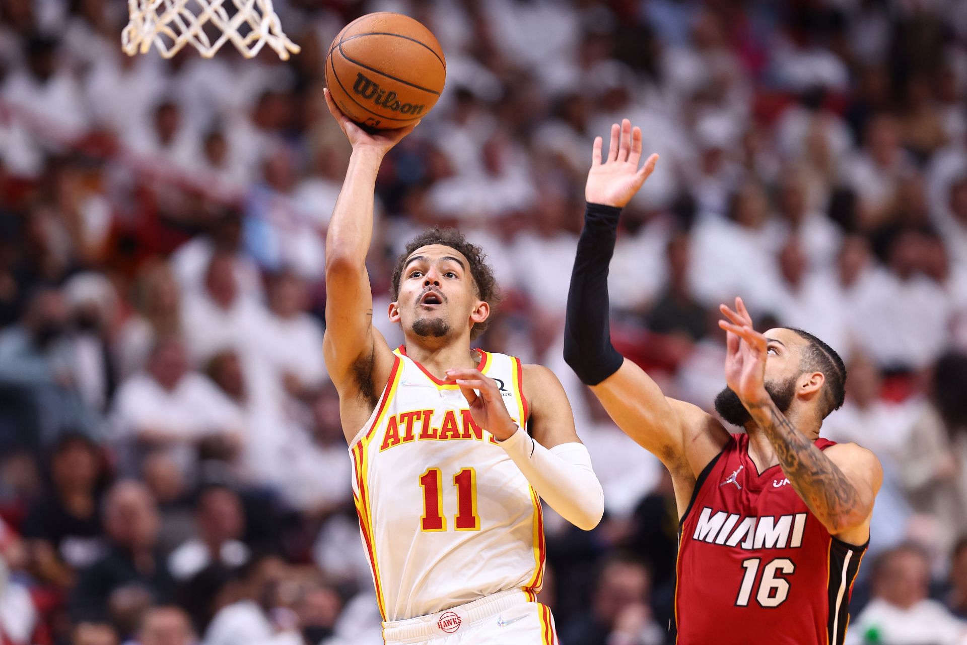 Trae Young of the Atlanta Hawks shoots against Caleb Martin of the Miami Heat.