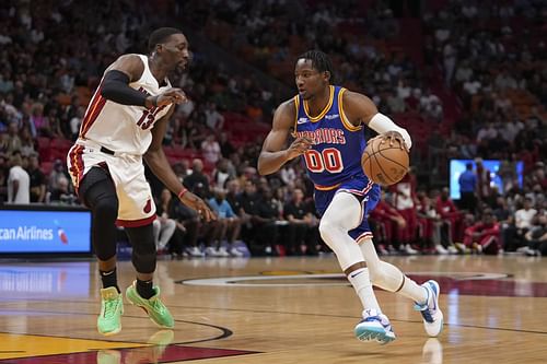 Jonathan Kuminga attempts to drive past Bam Adebayo.