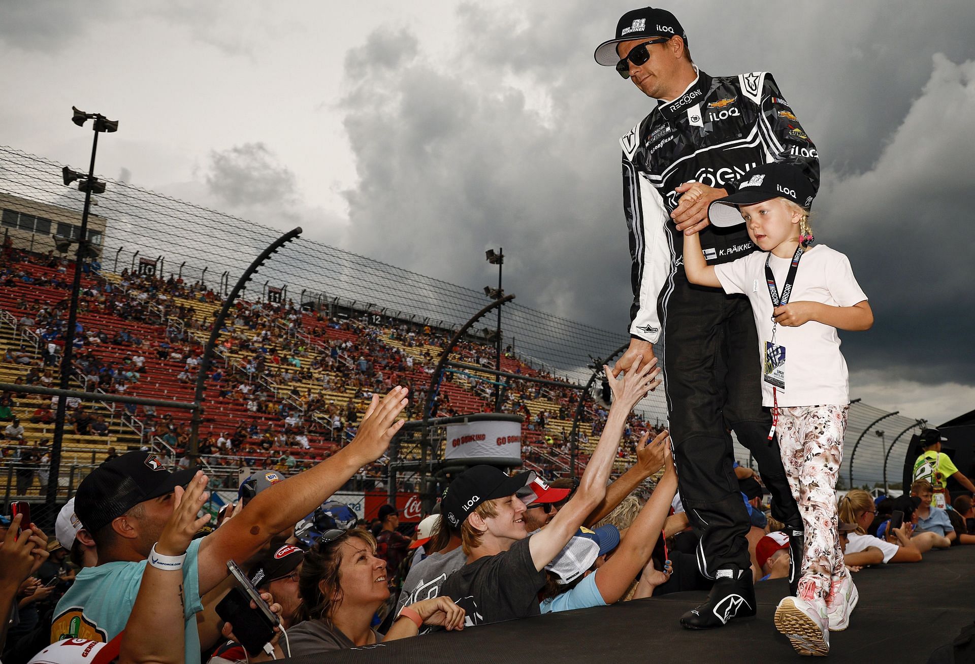 Kimi Raikkonen and daughter Rianna Angelia Milana Raikkonen greet fans as he walks onstage during driver intros before the 2022 NASCAR Cup Series Go Bowling at The Glen at Watkins Glen International in Watkins Glen, New York. (Photo by Chris Graythen/Getty Images)