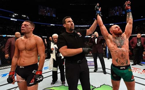 Nate Diaz (left), John McCarthy (middle), Conor McGregor (right); [Photo Credits: Josh Hedges/Zuffa LLC/Zuffa LLC via Getty Images]