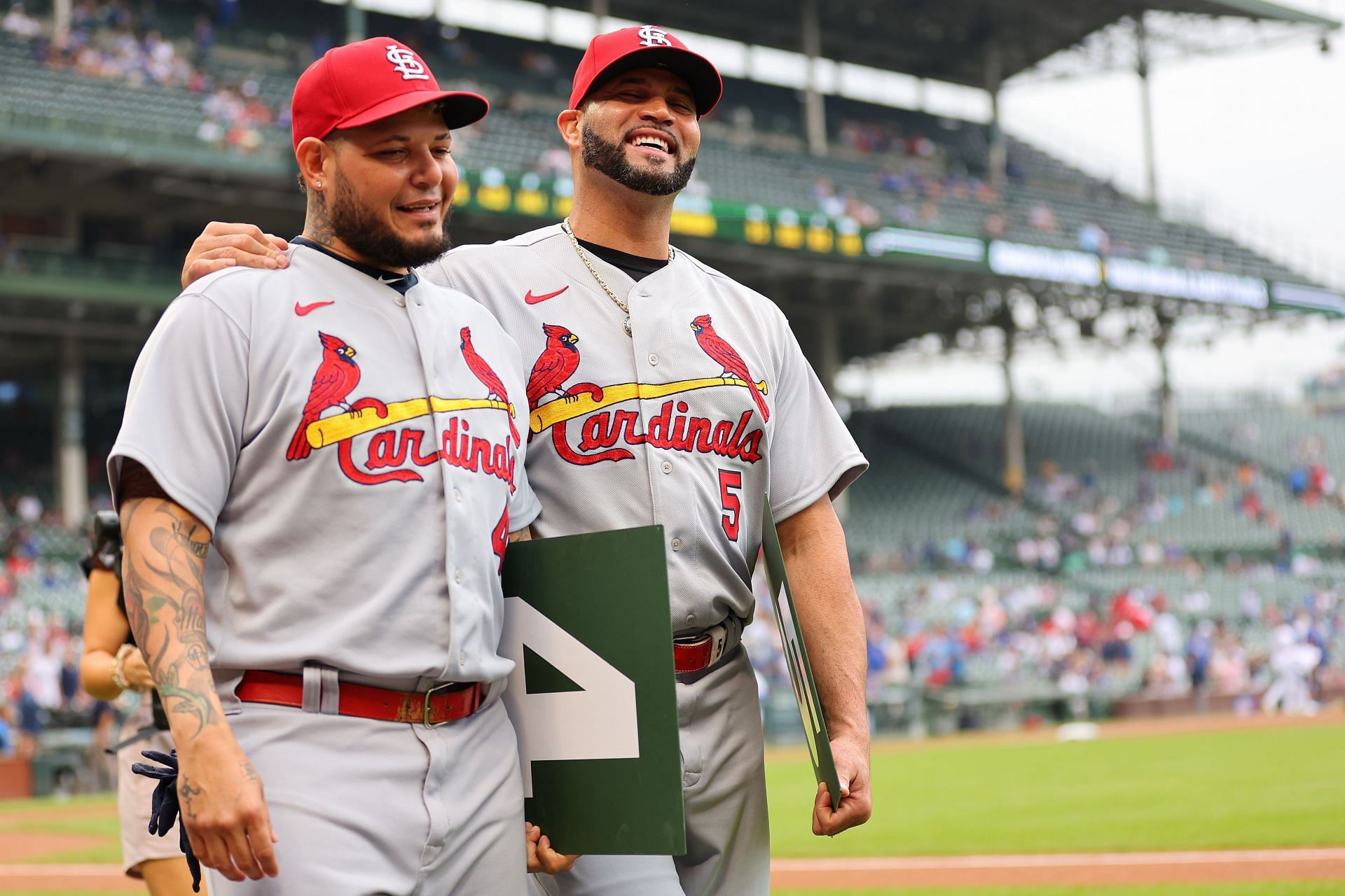 Yadier Molina and Albert Pujols walk back to the dugout after receiving a gift from the Chicago Cubs. MLB: St. Louis Cardinals v Chicago Cubs