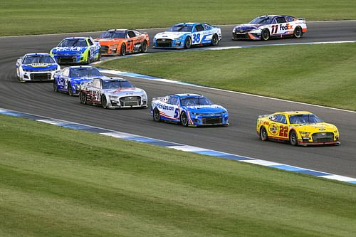 Joey Logano (#22 Pennzoil Ford) leads a pack of cars during the 2022 NASCAR Cup Series Verizon 200 at the Brickyard at Indianapolis Motor Speedway in Indianapolis, Indiana (Photo by Justin Casterline/Getty Images)