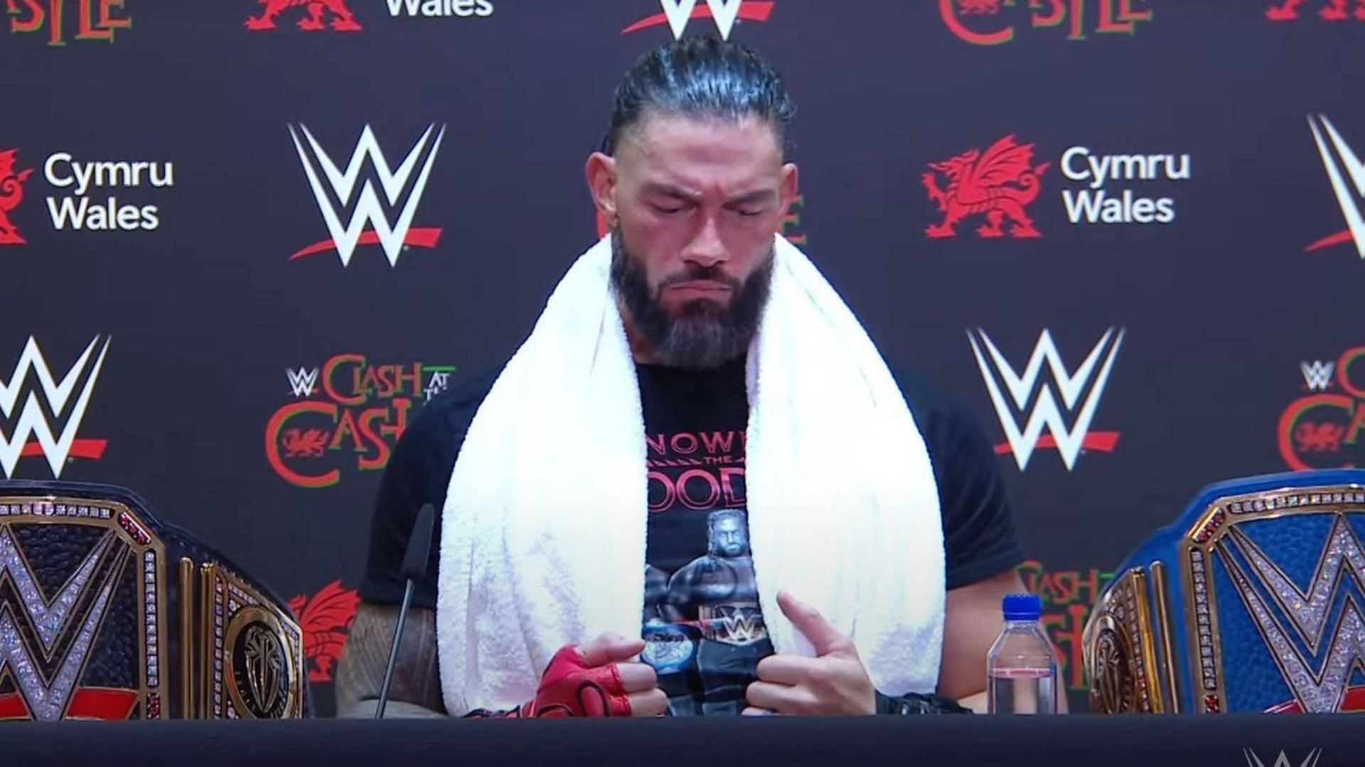 Roman Reigns shoved his upcoming title challenger at the Las Vegas press conference