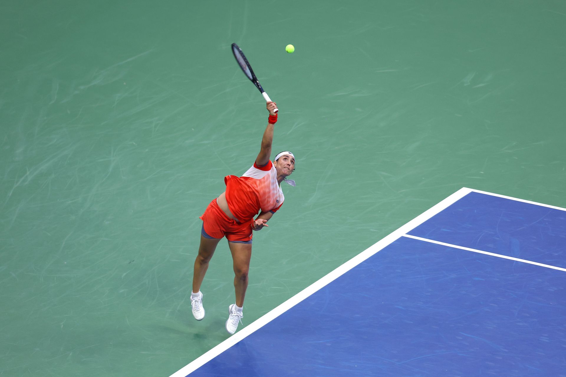 Ons Jabeur of Tunisia serves against Iga Swiatek of Poland at the 2022 US Open - Day 13