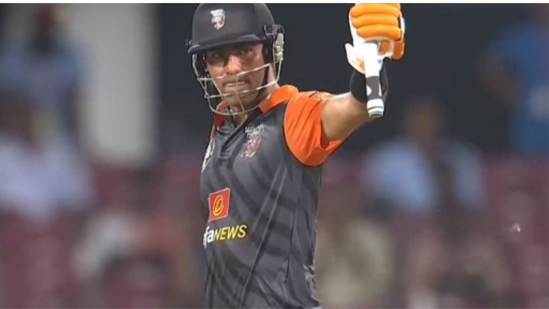 Mohammed Kaif raises his bat after scoring a half-century for the Manipal Tigers. 