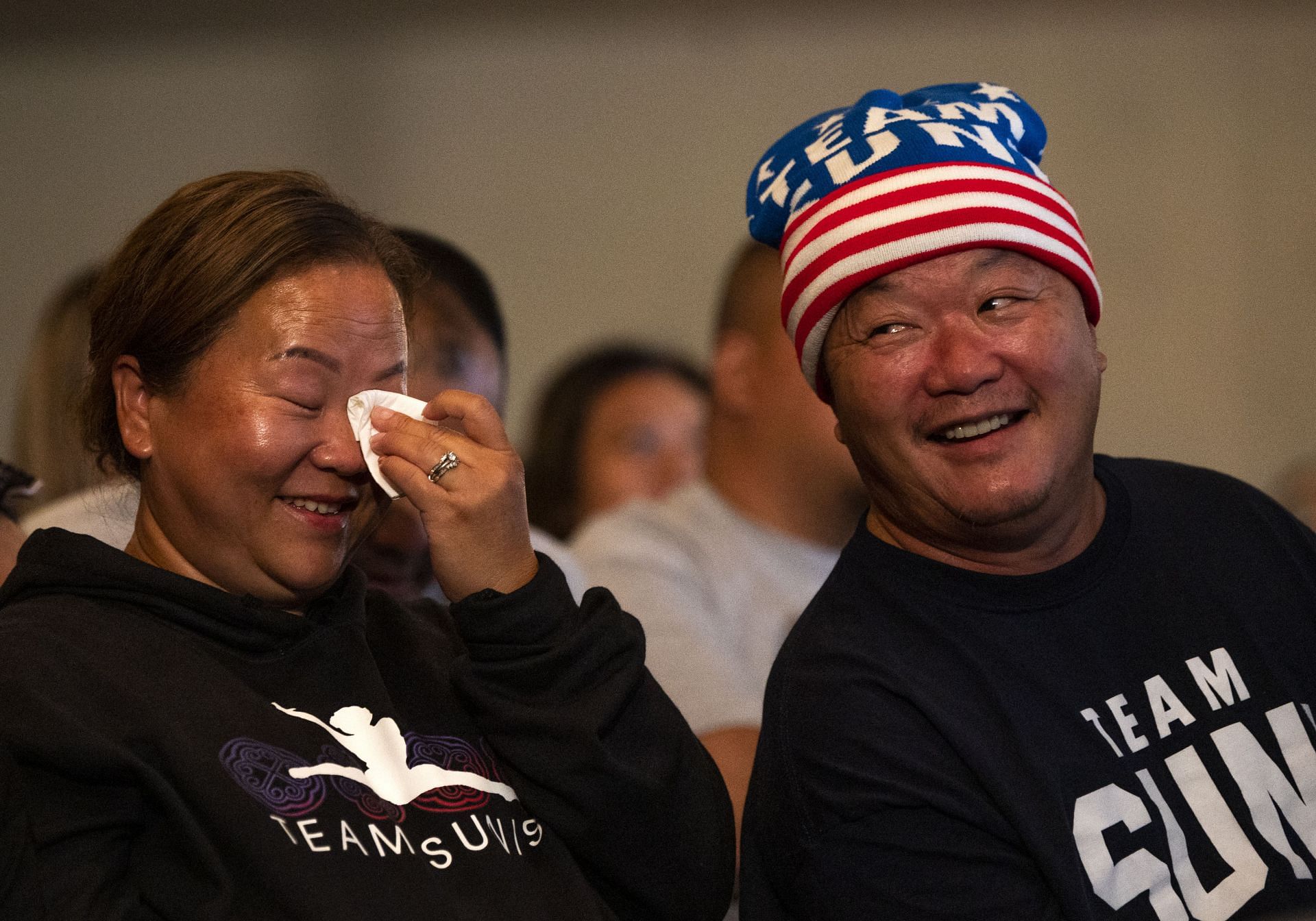 Yeev Thoj (left) and John Lee at the United States Olympic Gymnastics Viewing Event with members of the Hmong community (Image via Stephen Maturen/Getty Images)