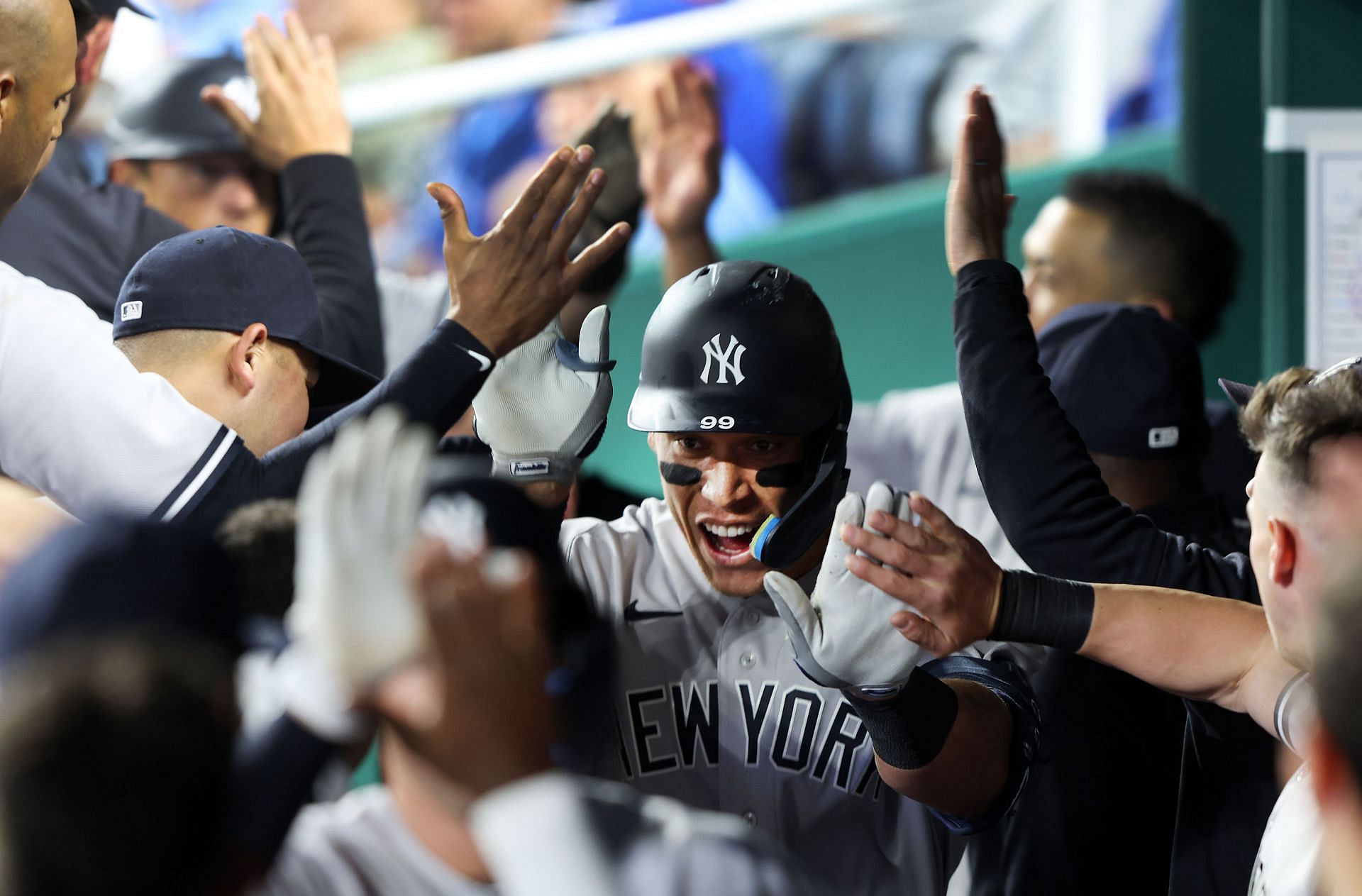 Aaron Judge is congratulated by teammates in the dugout after hitting a 3-run home run against the Kansas City Royals.
