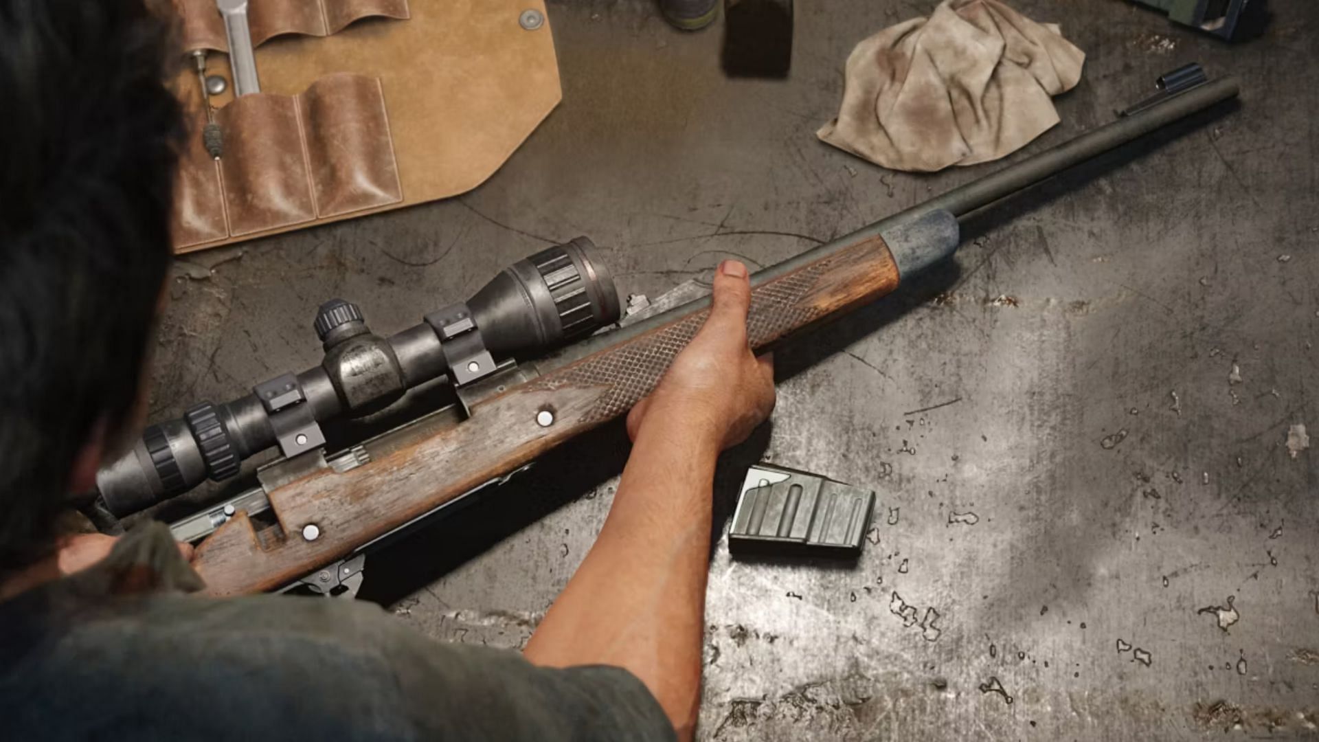 Joel fixing up the hunting rifle (Image via Naughty Dog)