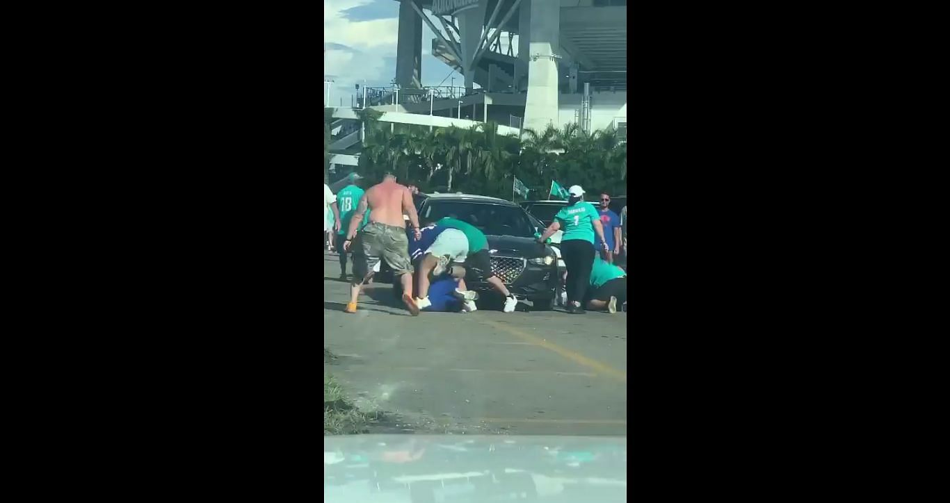 Bills fan gets kicked in the teeth during fight between Miami and Buffalo  fans at tailgate