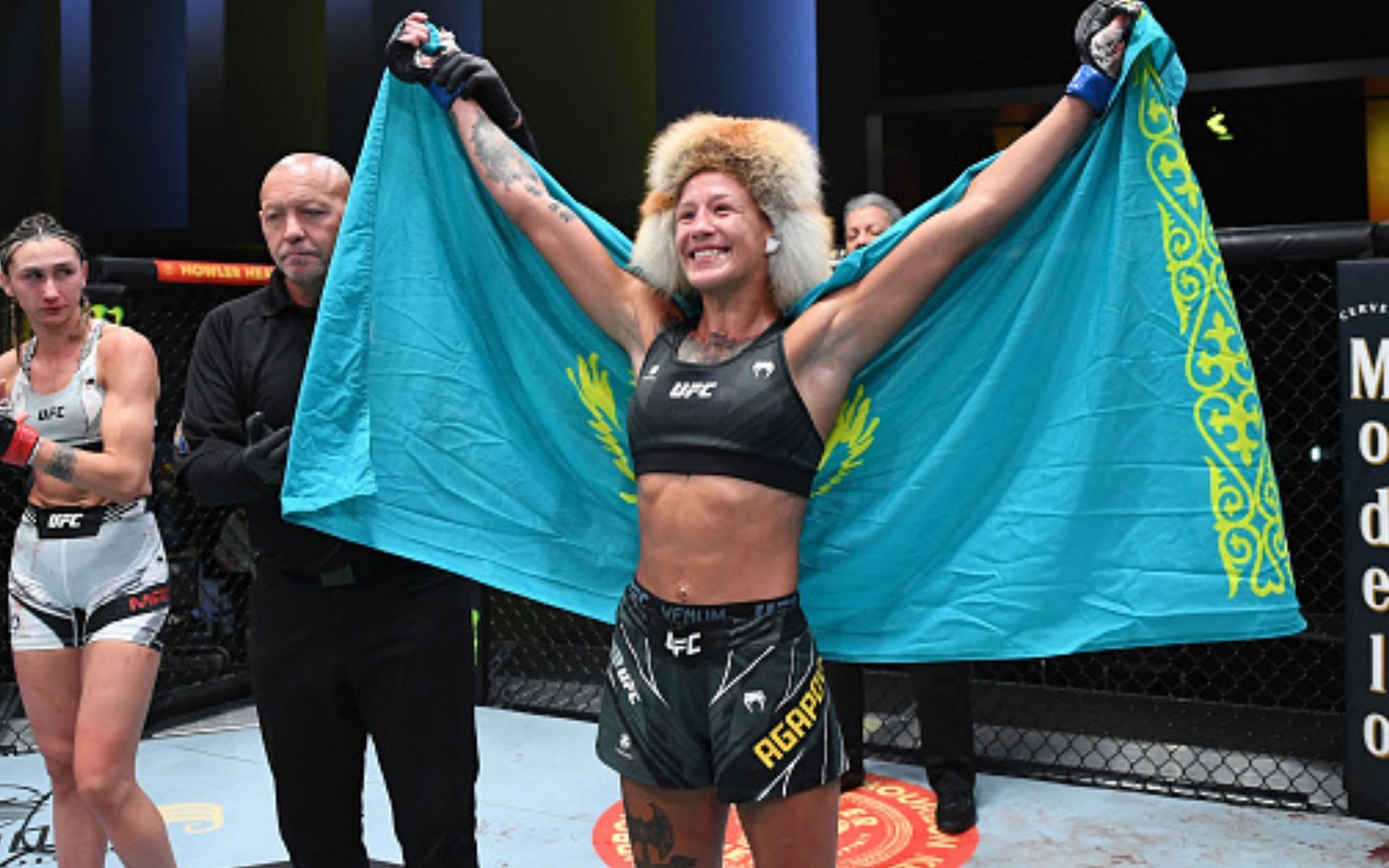 Mariya Agapova holding the Kazakhstan flag after a win (Image via Getty)