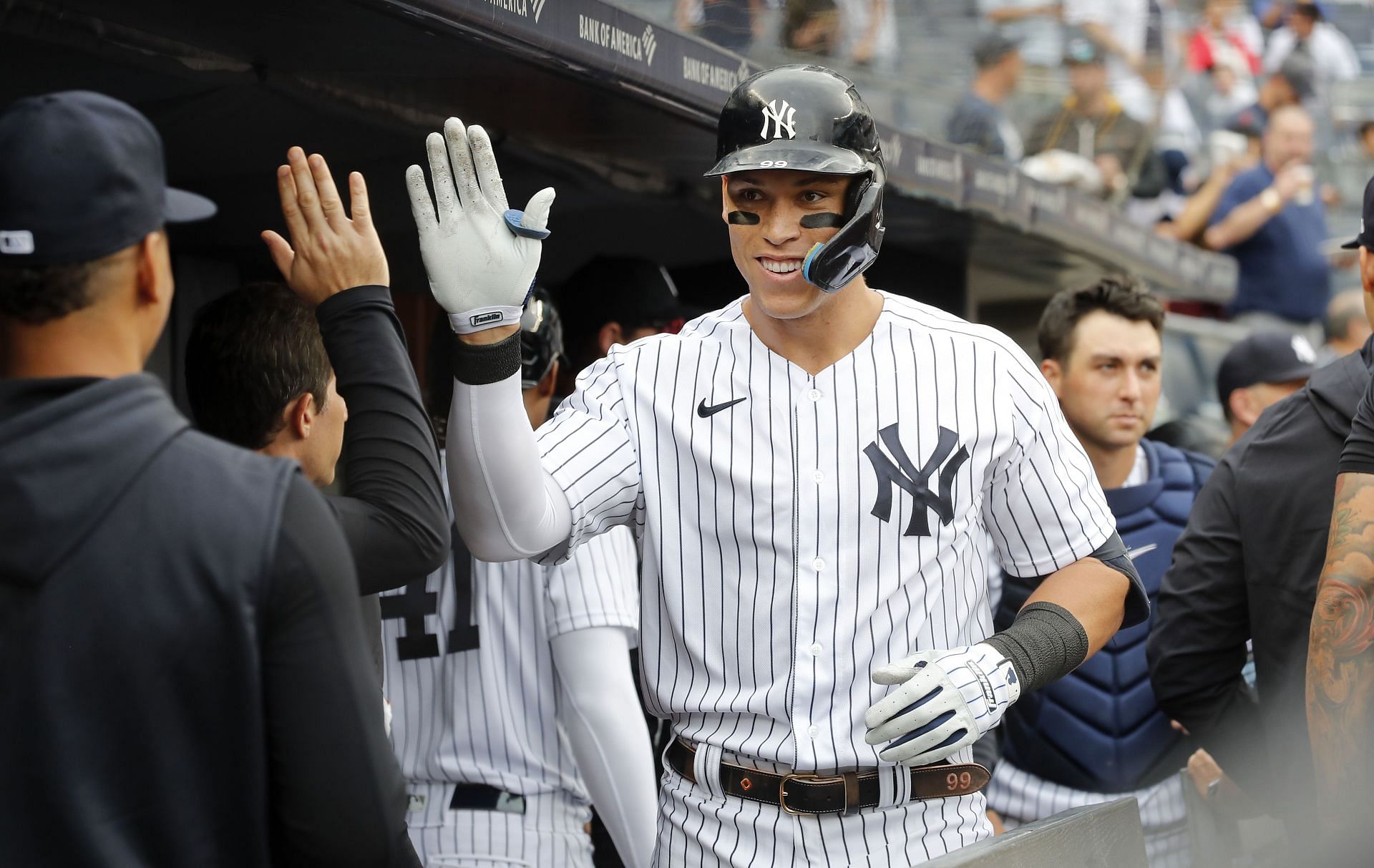 Aaron Judge celebrates his fourth inning home run against the Minnesota Twins in the dugout with his teammates