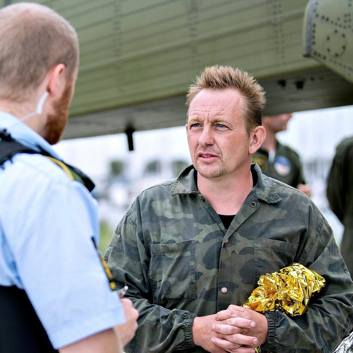 Madsen talking to the authorities after being rescued from a sinking Nautilus (Image via EPA)