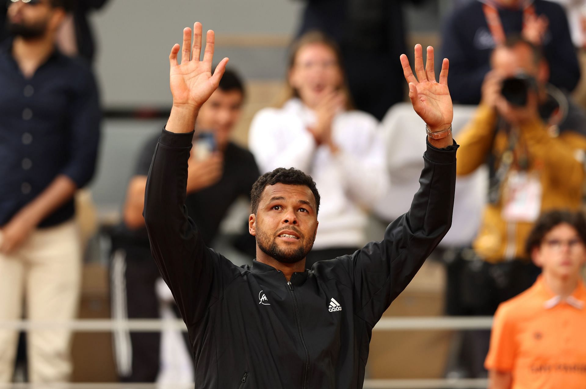 Jo-Wilfried Tsonga waves to the crowd during a presentation ceremony after his final career match at the 2022 Roland Garros.