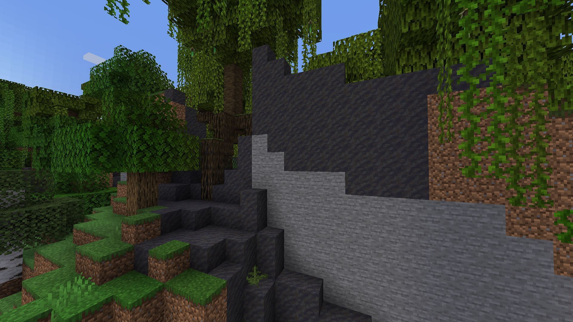 A cliff with a hidden entrance to a secret Minecraft base (Image via Mojang)