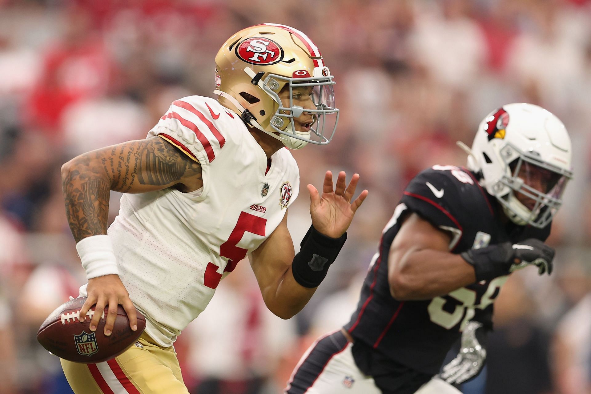 San Francisco 49ers quarterback Trey Lance rushes in a matchup against the Arizona Cardinals