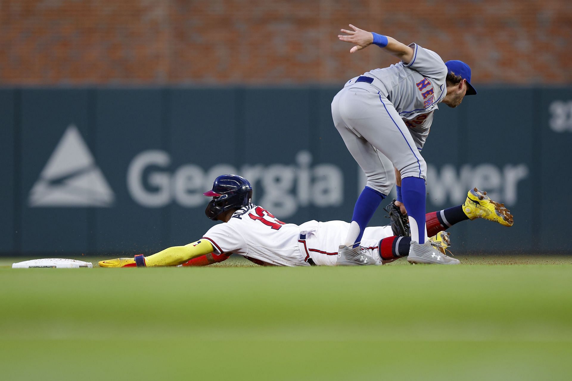 Ronald Acuna Jr. of the Atlanta Braves is tagged out by Jeff McNeil of the New York Mets at Truist Park