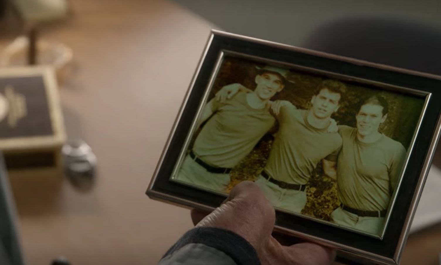 John Kreese holding an old photo from his years of service (Image via Netflix)