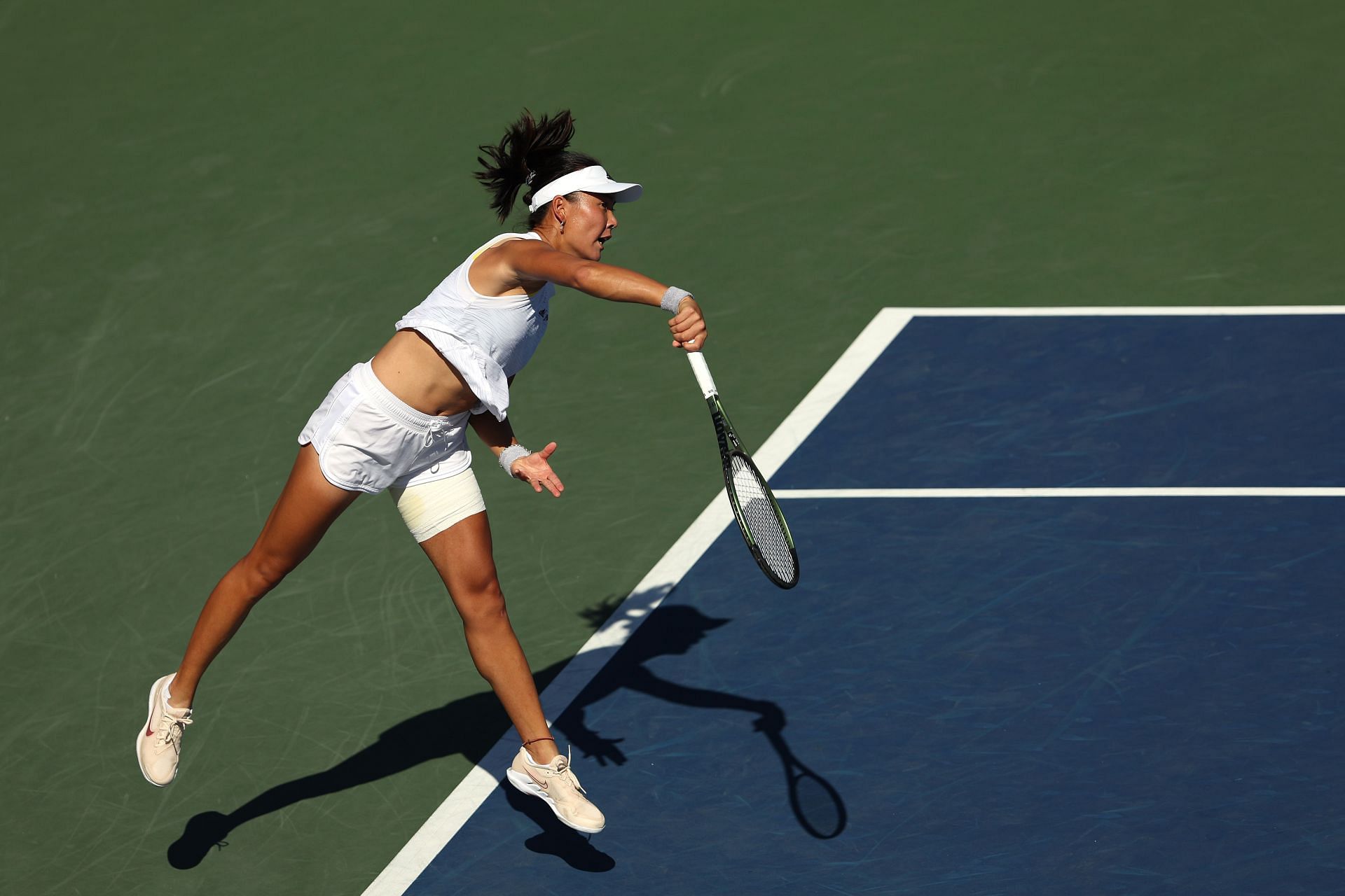 Yue Yuan serves at the 2022 US Open