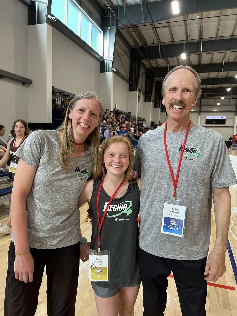 Ruthie with coach Phil Summers (right) after winning a medal at the junior level at the USA gymnastics competition. (Image via Jeff Wehrung)