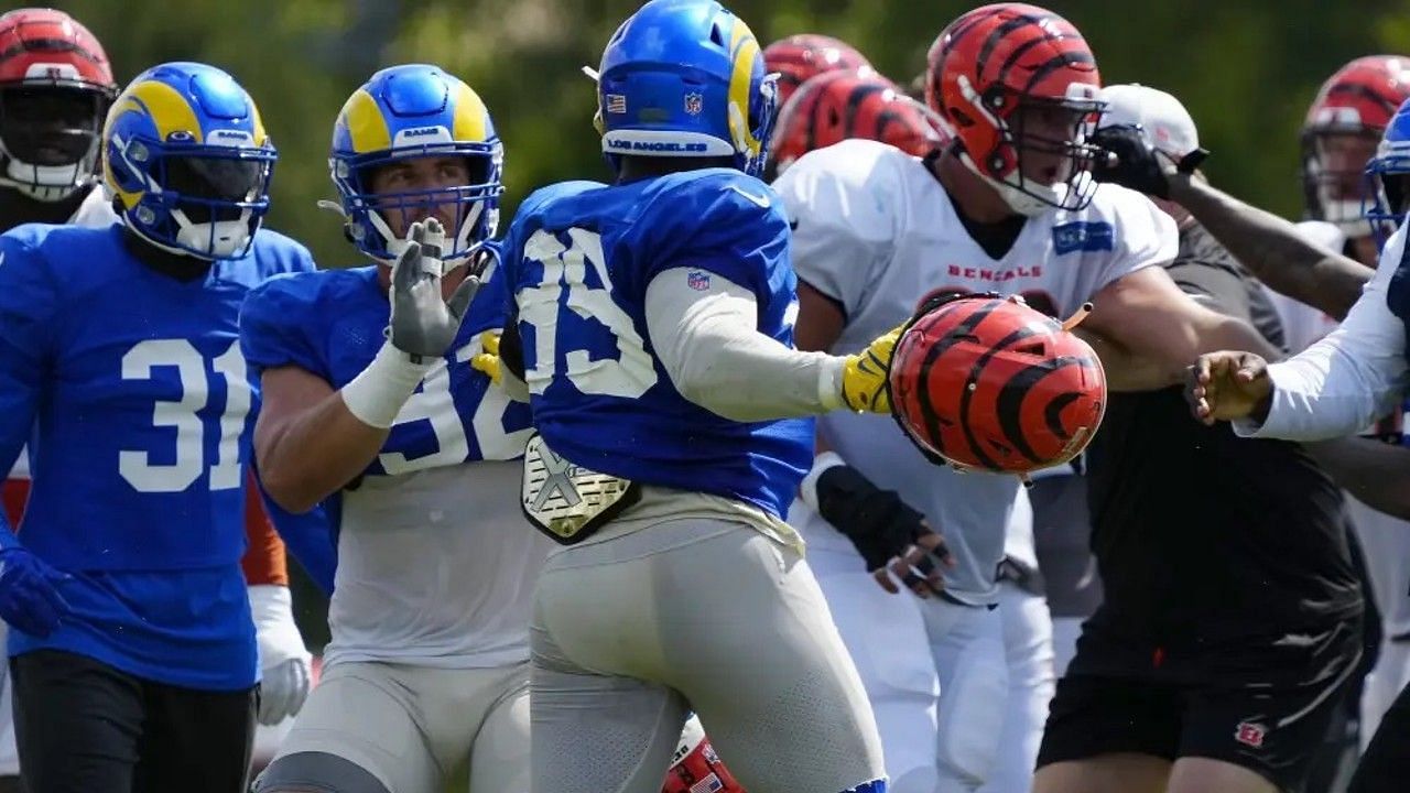 Aaron Donald wielding a Bengals helmet in practice