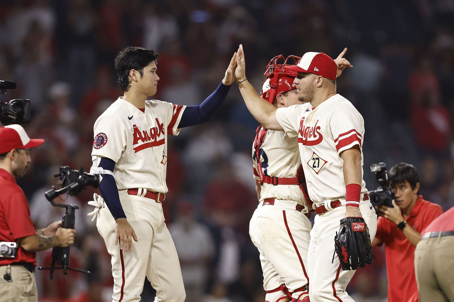 Shohei Ohtani celebrates with teammate Mike Trout after defeating the Oakland Athletics.