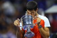 Carlos Alcaraz holding the champion's trophy at the 2022 US Open